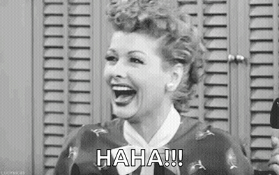 A Black And White Photo Of A Woman Laughing In Front Of A Locker Room . GIF