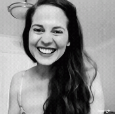 A Black And White Photo Of A Woman Laughing . GIF