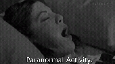 A Black And White Photo Of A Woman Laying In Bed With Her Mouth Open And The Words `` Paranormal Activity '' Below Her . GIF