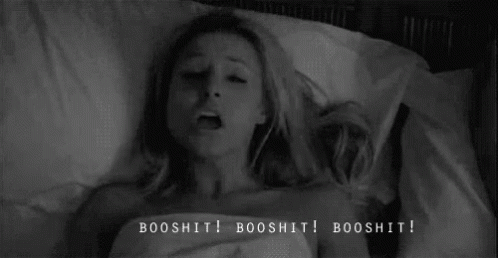 A Black And White Photo Of A Woman Laying In Bed With The Words Booshit Written On The Bottom . GIF
