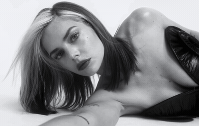 A Black And White Photo Of A Woman Laying On Her Stomach GIF