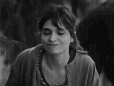 A Black And White Photo Of A Woman Making A Funny Face And Giving A Thumbs Up . GIF