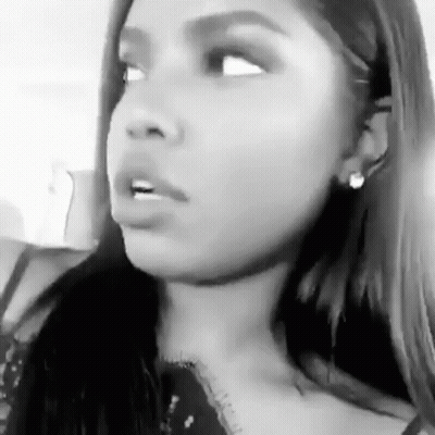A Black And White Photo Of A Woman Making A Funny Face With Her Mouth Open . GIF