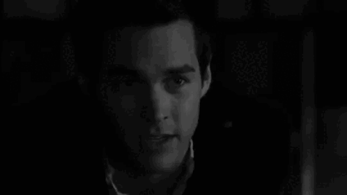 A Black And White Photo Of A Woman 'S Face . GIF
