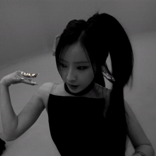 A Black And White Photo Of A Woman 'S Face And Hands GIF