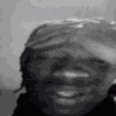 A Black And White Photo Of A Woman 'S Face Smiling . GIF