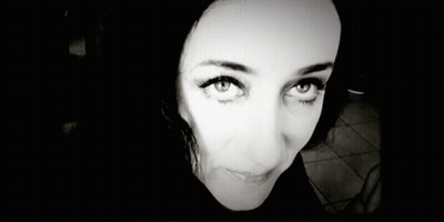 A Black And White Photo Of A Woman 'S Face Smiling GIF