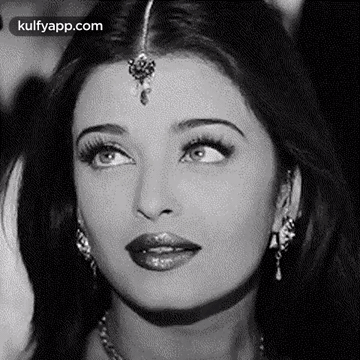 A Black And White Photo Of A Woman 'S Face With A Bindi On Her Forehead . GIF