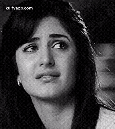 A Black And White Photo Of A Woman 'S Face With A Sad Look On Her Face . GIF