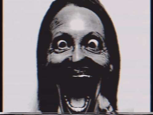 A Black And White Photo Of A Woman 'S Face With A Surprised Expression GIF