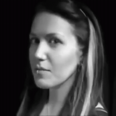 A Black And White Photo Of A Woman 'S Face With Long Hair GIF