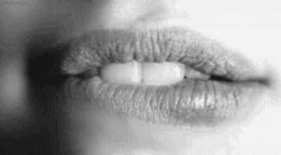 A Black And White Photo Of A Woman 'S Lips With Lipstick On Them . GIF