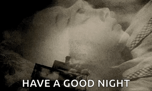 A Black And White Photo Of A Woman Sleeping In A Bed With The Words `` Have A Good Night '' Written Above Her . GIF