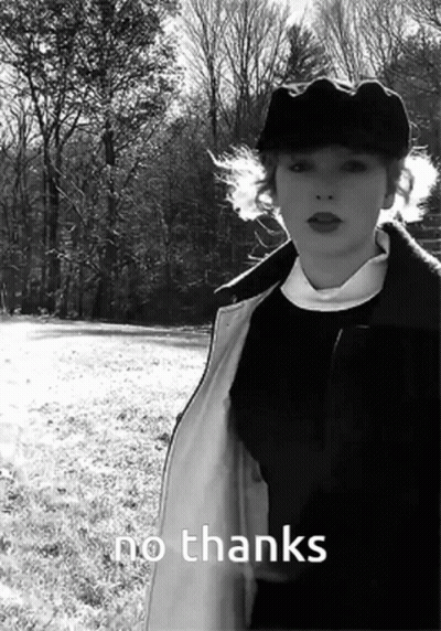 A Black And White Photo Of A Woman Standing In A Field With The Words No Thanks Written Below Her GIF