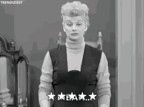 A Black And White Photo Of A Woman Standing In Front Of A Mirror Giving Five Stars . GIF