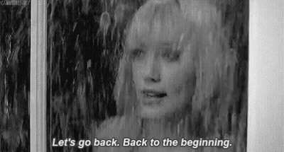 A Black And White Photo Of A Woman Standing In The Rain And Talking . GIF