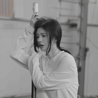 A Black And White Photo Of A Woman Taking A Selfie GIF