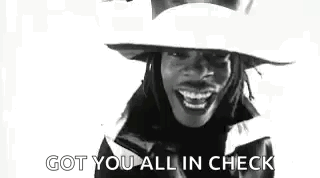 A Black And White Photo Of A Woman Wearing A Hat And Smiling With The Words `` Got You All In Check '' . GIF