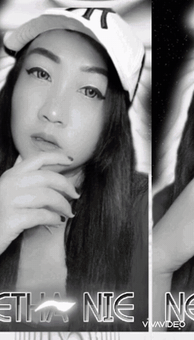 A Black And White Photo Of A Woman Wearing A Hat With The Word Ethan On The Bottom Right GIF