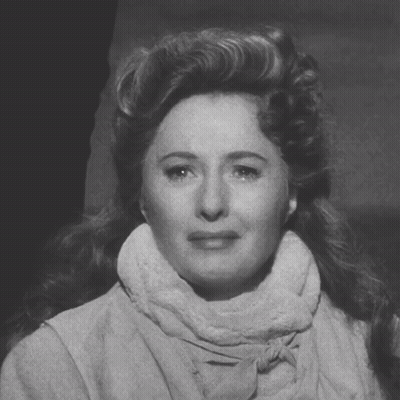 A Black And White Photo Of A Woman Wearing A Scarf Around Her Neck GIF