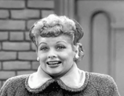 A Black And White Photo Of A Woman Wearing A Sweater And Earrings . GIF