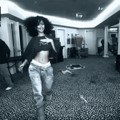 A Black And White Photo Of A Woman Wearing A Tyia Crop Top GIF