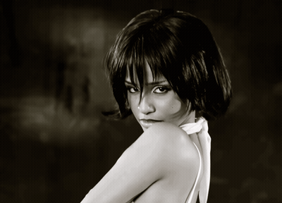 A Black And White Photo Of A Woman Wearing A White Top GIF