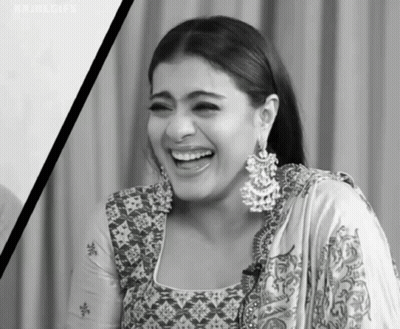 A Black And White Photo Of A Woman Wearing Earrings Laughing . GIF