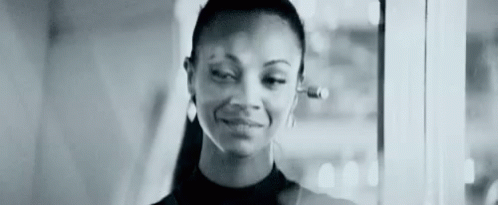 A Black And White Photo Of A Woman Wearing Headphones . GIF