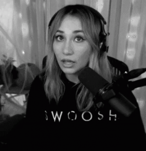A Black And White Photo Of A Woman Wearing Headphones And A Sweatshirt With The Word Swoosh On It . GIF