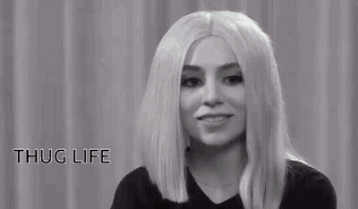 A Black And White Photo Of A Woman Wearing Sunglasses . GIF