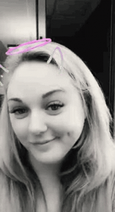 A Black And White Photo Of A Woman With A Filter On Her Face GIF