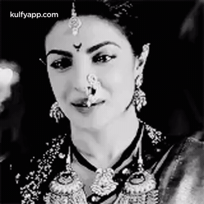 A Black And White Photo Of A Woman With A Nose Ring On Her Nose . GIF
