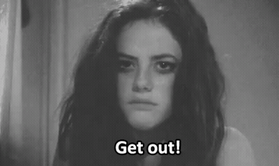 A Black And White Photo Of A Woman With A Sad Look On Her Face . GIF