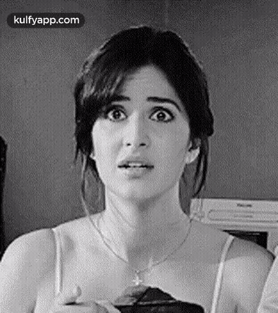 A Black And White Photo Of A Woman With A Surprised Look On Her Face And A Necklace . GIF