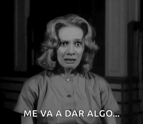 A Black And White Photo Of A Woman With A Surprised Look On Her Face And The Words Me Va A Dar Algo . GIF