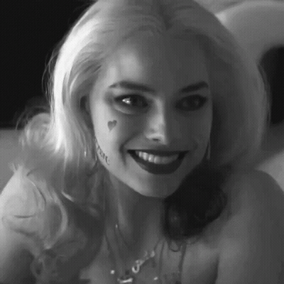 A Black And White Photo Of A Woman With A Tattoo On Her Face . GIF