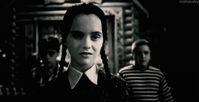 A Black And White Photo Of A Woman With Braids Making A Funny Face . GIF