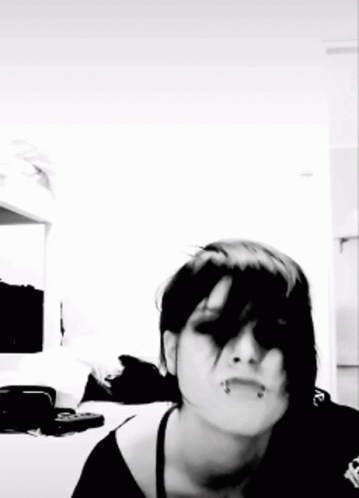 A Black And White Photo Of A Woman With Dark Hair GIF