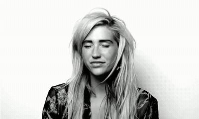 A Black And White Photo Of A Woman With Her Eyes Closed And A Nose Piercing . GIF