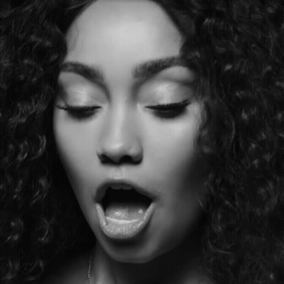 A Black And White Photo Of A Woman With Her Mouth Open And Her Tongue Sticking Out GIF