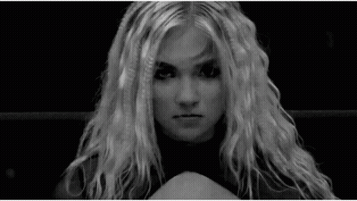 A Black And White Photo Of A Woman With Long Blonde Hair Making A Funny Face . GIF