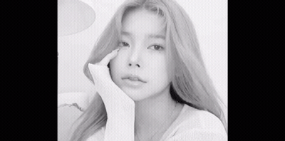 A Black And White Photo Of A Woman With Long Blonde Hair Taking A Selfie . GIF