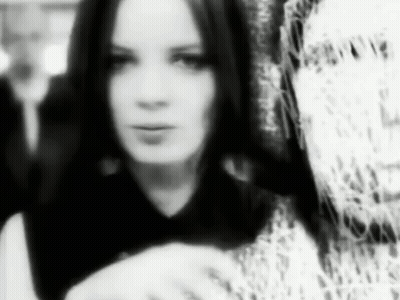 A Black And White Photo Of A Woman With Long Hair In A Black And White Photo . GIF