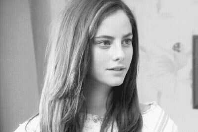 A Black And White Photo Of A Woman With Long Hair . GIF