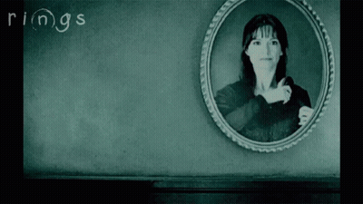A Black And White Photo Of A Woman With The Word Rings Written On The Wall GIF