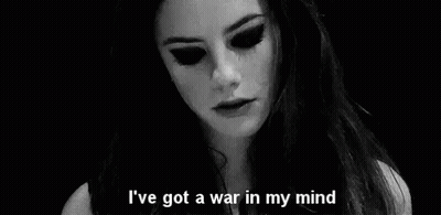A Black And White Photo Of A Woman With The Words `` I 'Ve Got A War In My Mind '' Written On It . GIF