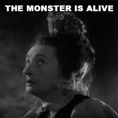 A Black And White Photo Of A Woman With The Words The Monster Is Alive Above Her GIF