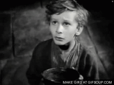 A Black And White Photo Of A Young Boy Holding A Cup GIF
