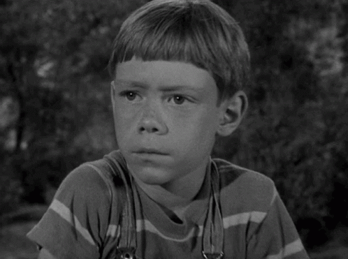 A Black And White Photo Of A Young Boy GIF